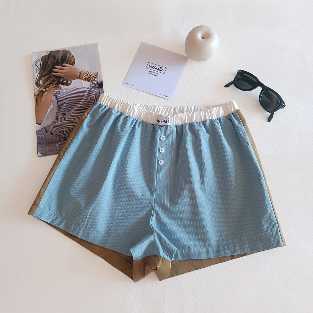 Light blue shorts with aqua green stripes and tobacco back