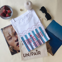Load image into Gallery viewer, Light blue striped t-shirt in a frame
